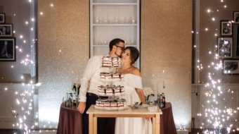 newlyweds happily cut, laugh and taste the wedding cake