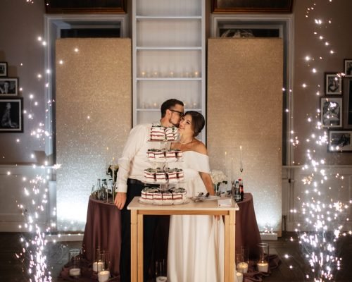 newlyweds happily cut, laugh and taste the wedding cake